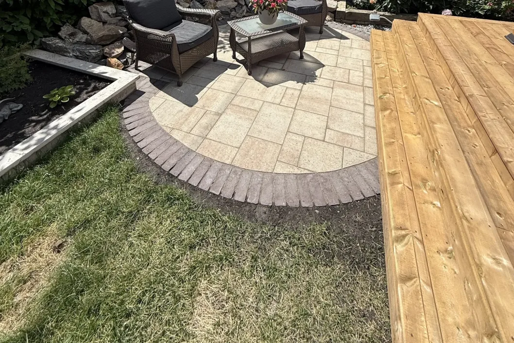 Curved paver patio with cedar deck and firepit seating area, Calgary