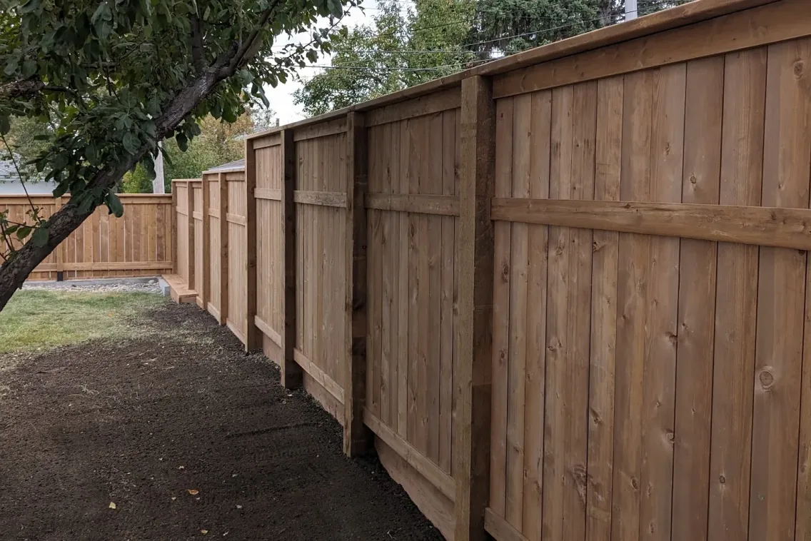 Finished cedar privacy fence along residential side yard, Calgary