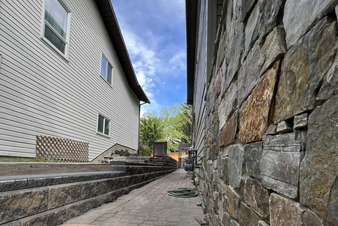 Natural stone retaining wall close-up by All The Moore Landscaping Calgary