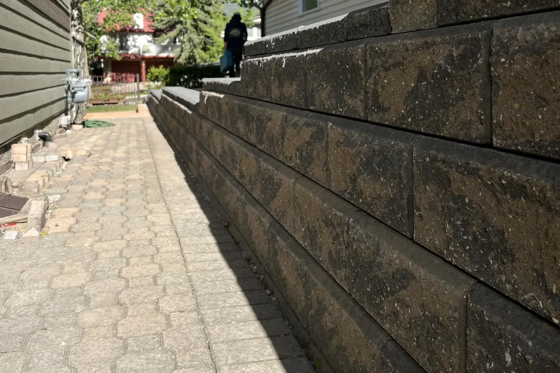 Dark charcoal retaining wall block installation in Calgary